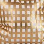 Close-up of Paloma pillow’s textured gold grid and ivory squares.